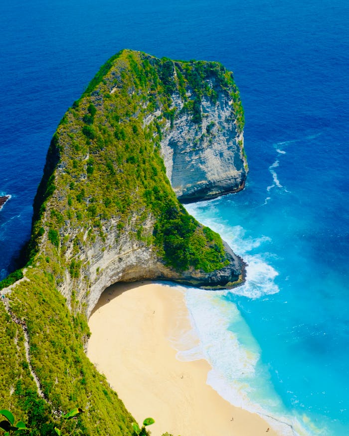 A breathtaking aerial shot of the iconic T-Rex shaped rock at Kelingking Beach, Bali.